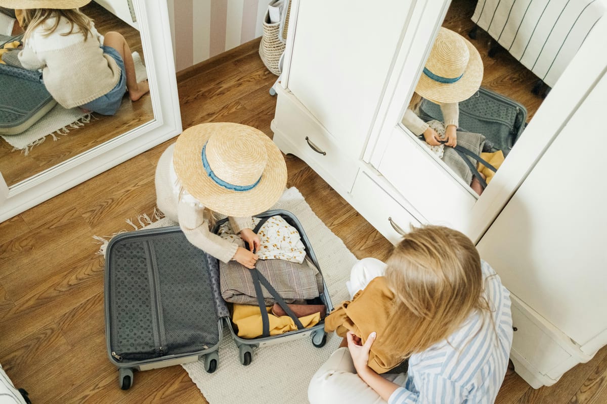 Woman and child packing a suitcase